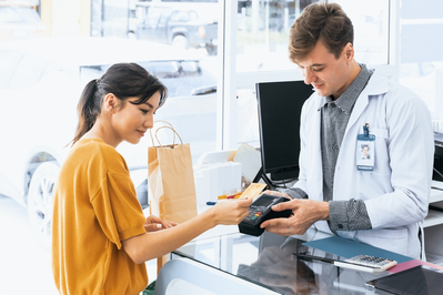 customer buying product at pharmacy