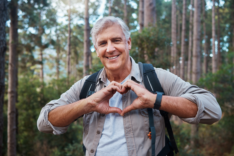 elder man making a heart with his hands